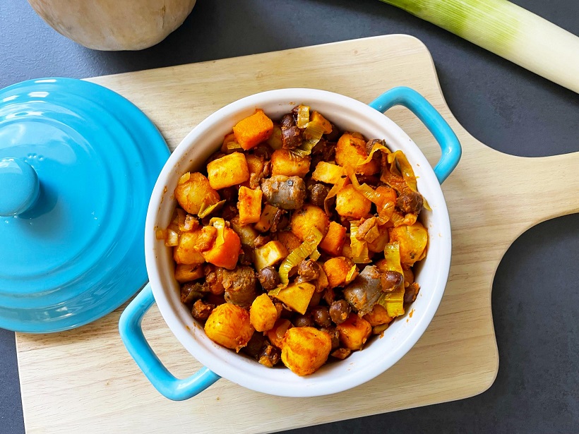 Pompoen-pastinaakschotel met kapucijners, krieltjes en worstjes